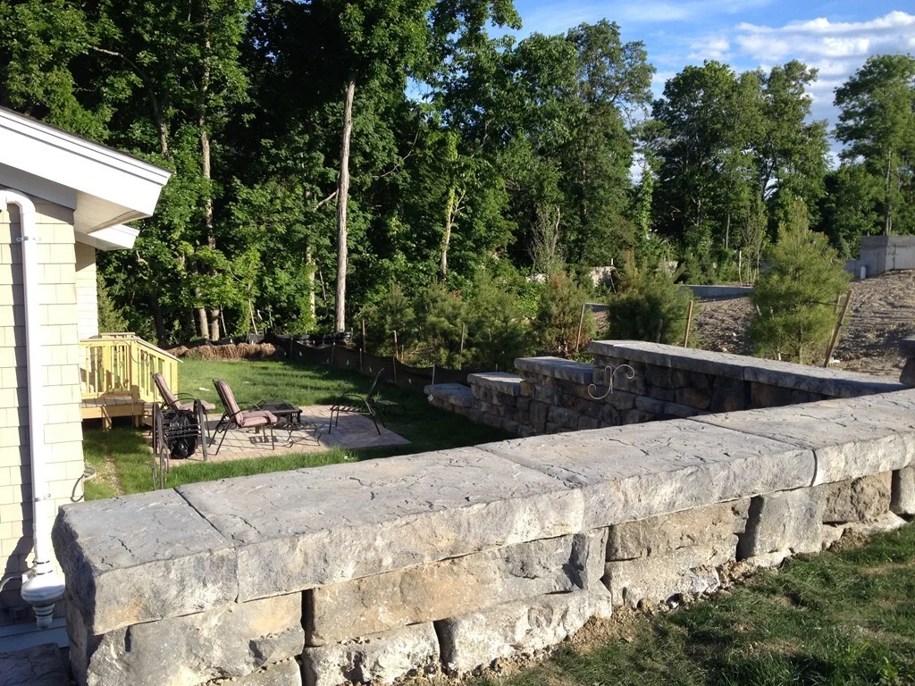 exterior patio with stone wall