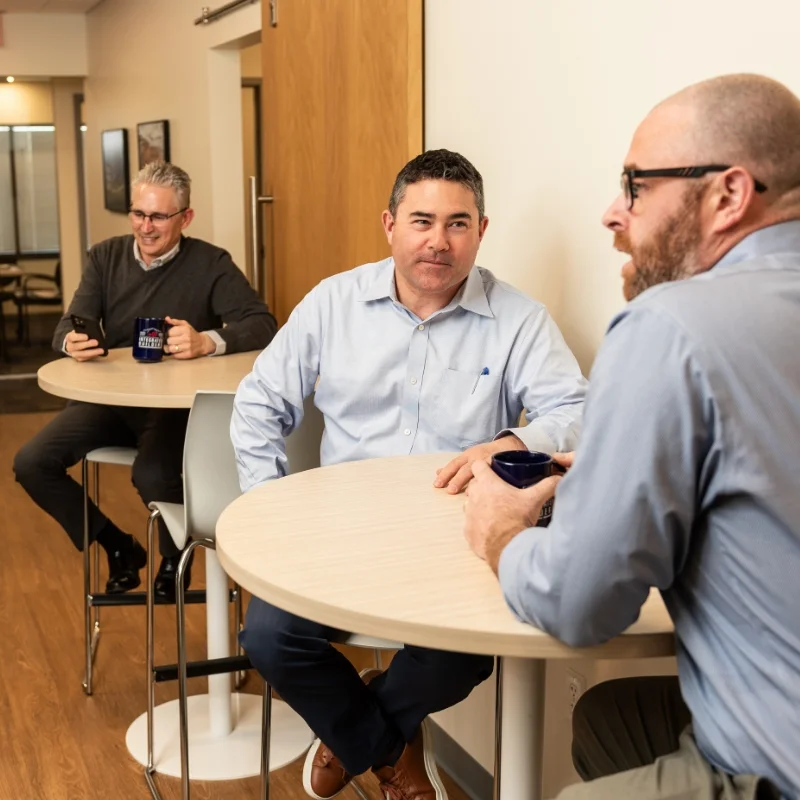employees sitting at round tables