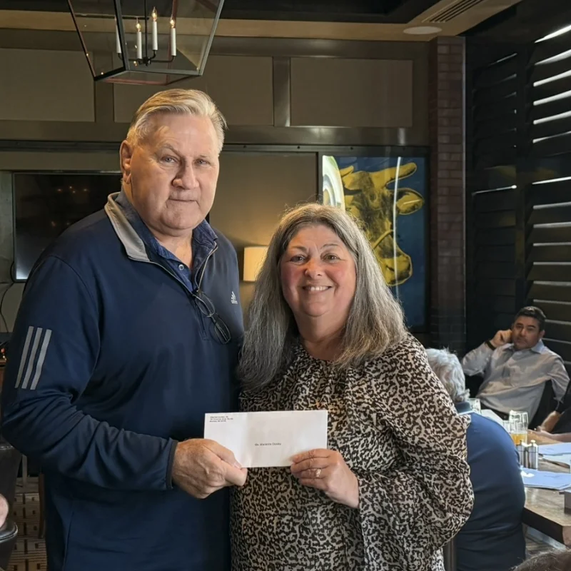 Jay Darcey and Marianne Dooley holding an envelope