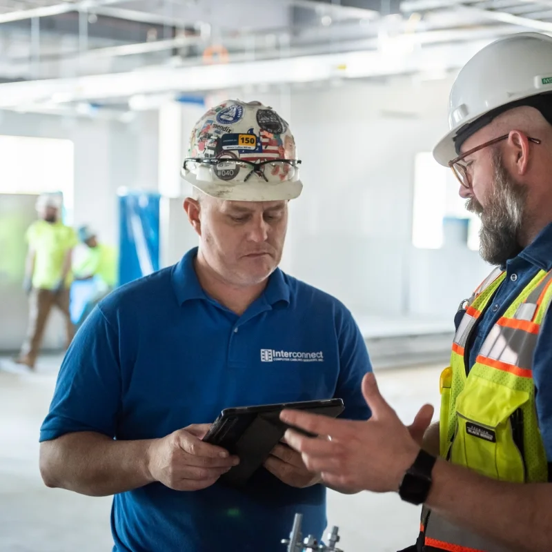 Integrated Builders project managers in hardhats on a construction site