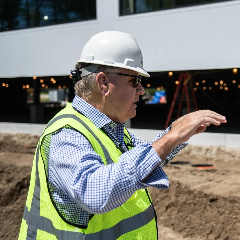 Integrated Builders principal and project manager in safety gear at a construction site