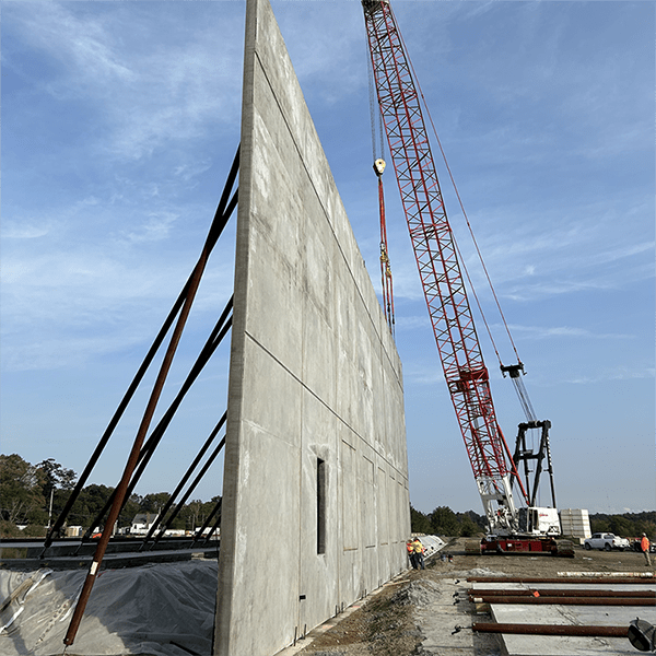 Installation of concrete tilt wall panels underway in Easton, MA